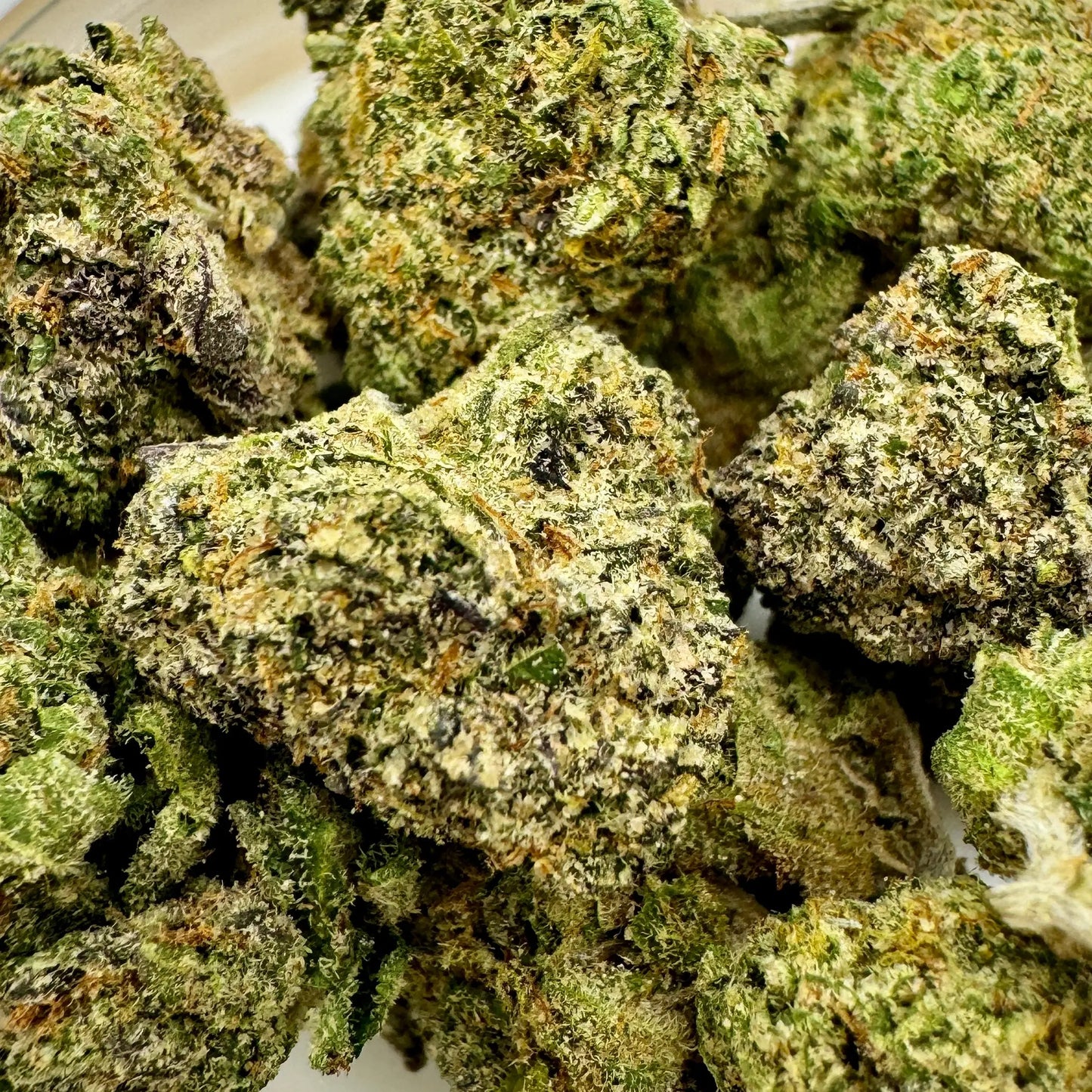 close up of cannabis flower top shelf with lots of crystals bright green