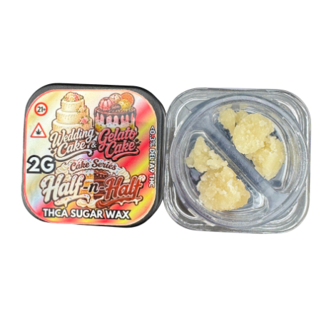 Two small square containers of sugar wax shown on a plain white background. The left container is closed with a colorful printed label reading 'Wedding Cake & Gelato Cake' and 'Half-in-Half' and 'THCA SUGAR WAX 2G.