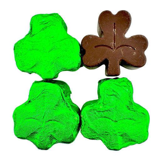 Four green and one brown four-leaf clover-shaped objects on a white background