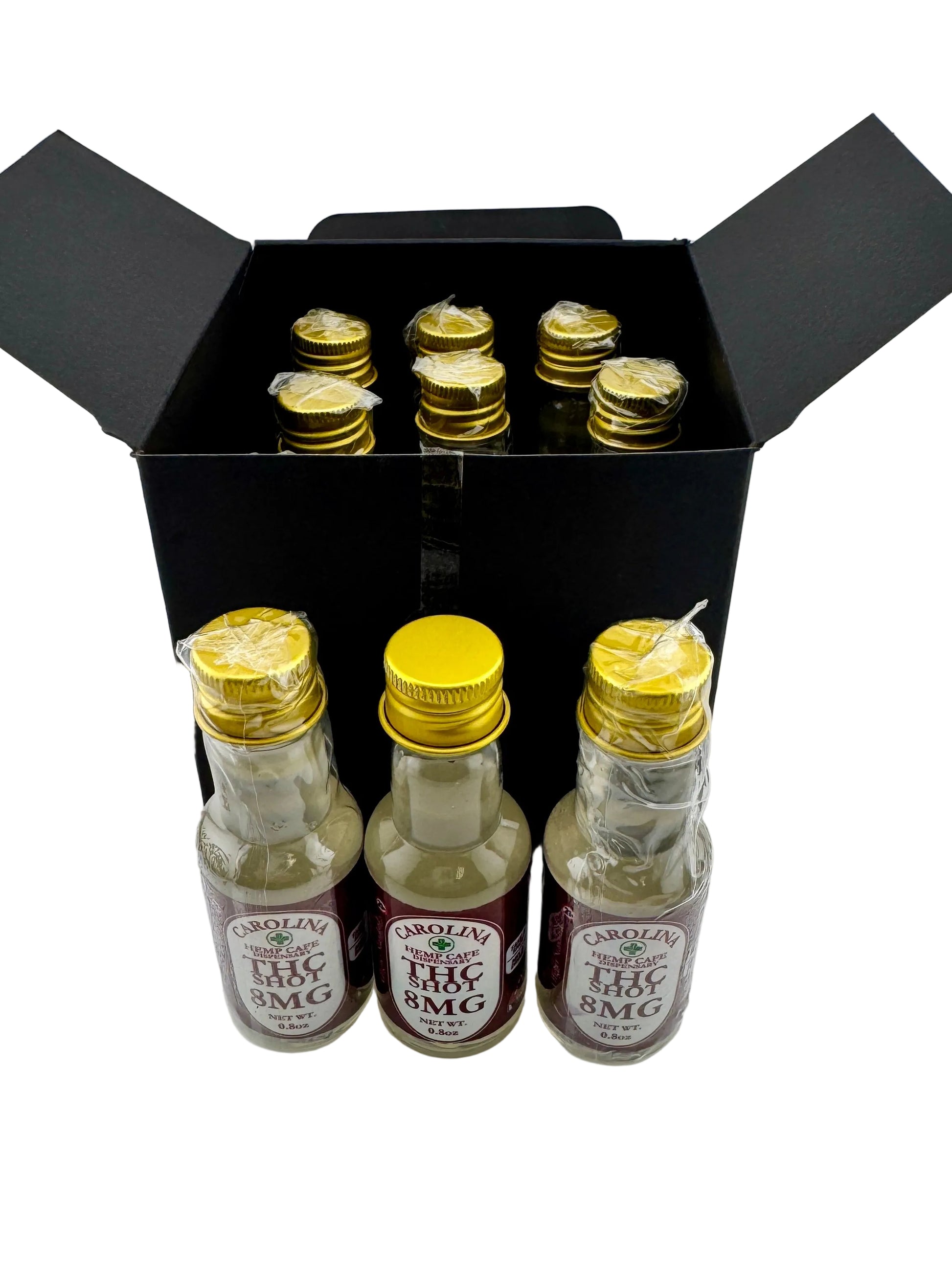 Three small bottles with gold caps and labels in a black box on a white background