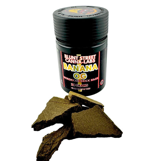 Black container labeled 'Blunt Street Canna Labs Banana OG' with cannabis buds on a white background