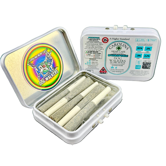 Container with rolled joints and a Carolina Hemp Cafe package on a gray surface