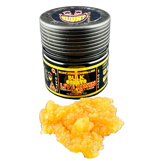 Jar of bulk grade live resin concentrate with a clump on a gray surface