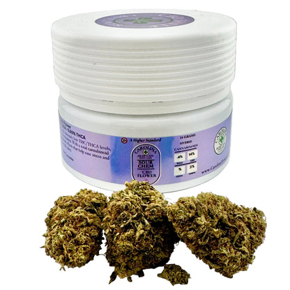 White jar with purple label containing cannabis buds on a white background