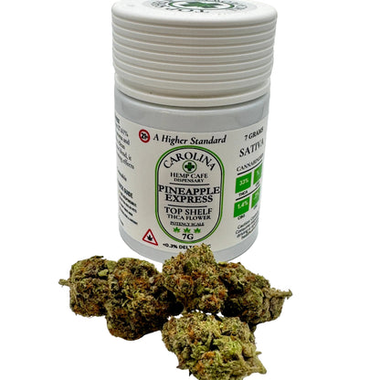 Jar of Carolina Hemp Cafe Dispensary Pineapple Express cannabis flower on a white background