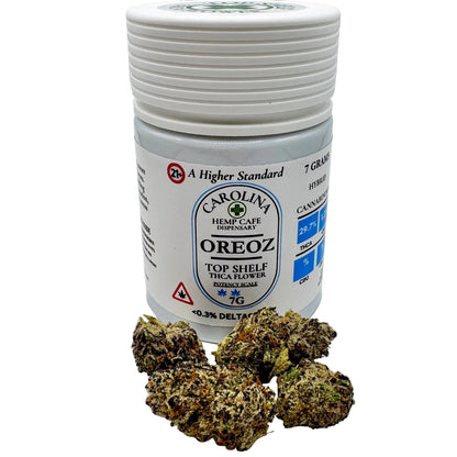 Jar of Carolina Hemp Cafe OREOZ cannabis with cannabis buds on a white background