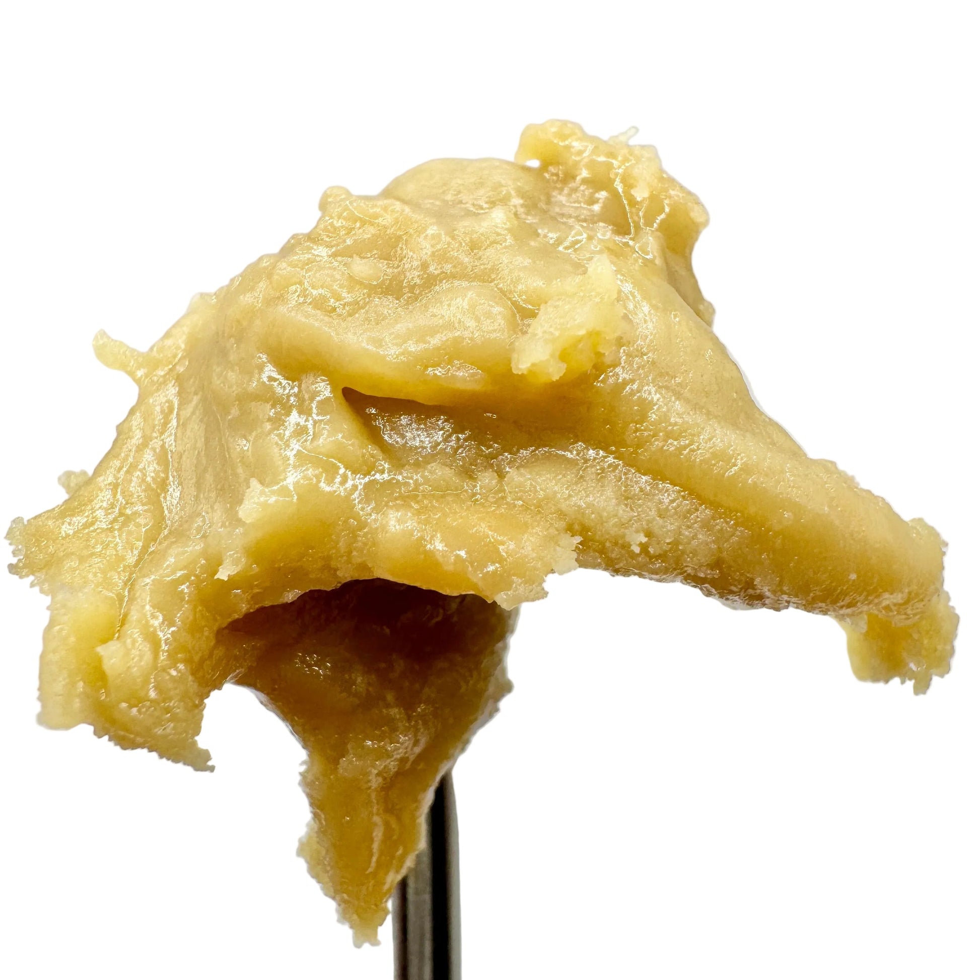 Mound of yellowish cream on a spoon against a light gray background