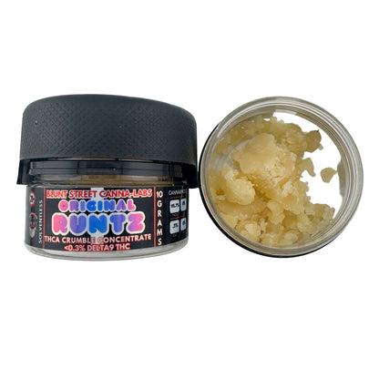 Open container of cannabis concentrate with visible product inside on a white background