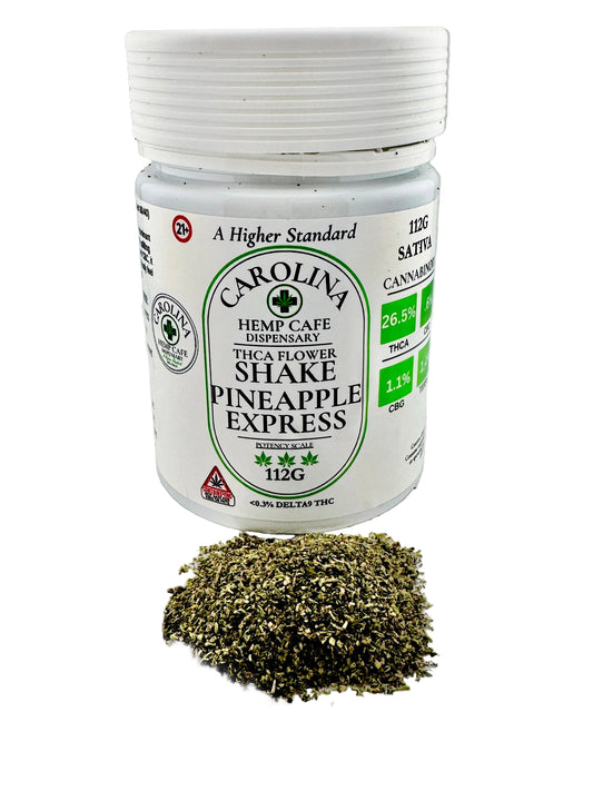 Jar of Carolina Hemp Cafe Pineapple Express flower shake on a gray background