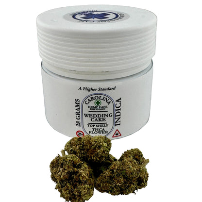 Jar of Carolina Hemp Cake Indica flower with cannabis buds on a white background