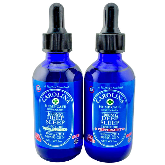 Two blue bottles of Carolina Hemp Cafe Deep Sleep Tincture on a gray background