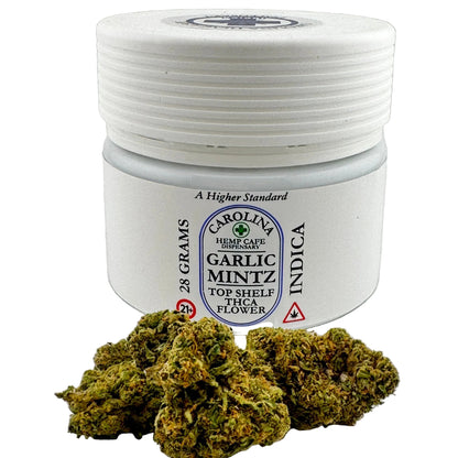 Jar of Carolina Hemp Cafe dispensary Garlic Mintz Indica flower on a light gray background