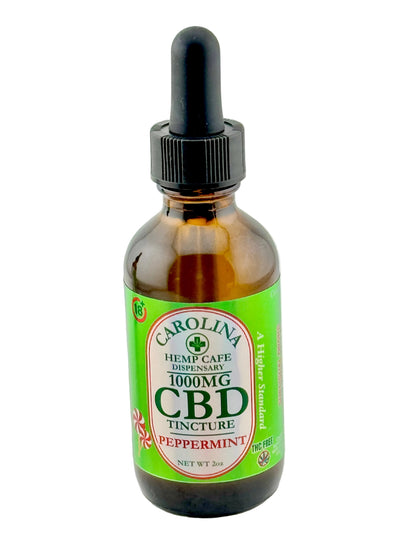 CBD tincture bottle with dropper labeled 'Carolina Herb Cafe' on a white background