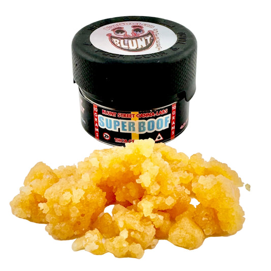 Jar of cannabis concentrate with a visible brand label on a white background