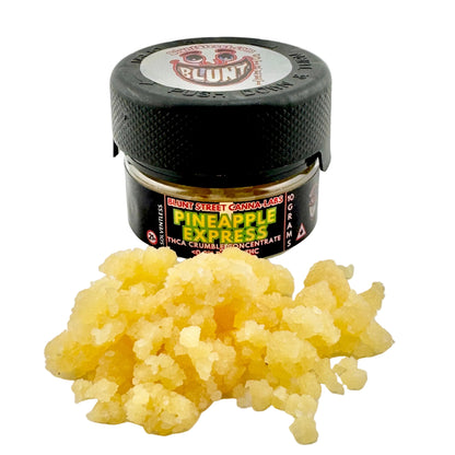 Jar of Pineapple Express concentrate with a black lid on a light gray background