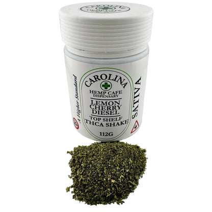 Jar of dried herbs with a label on a white surface