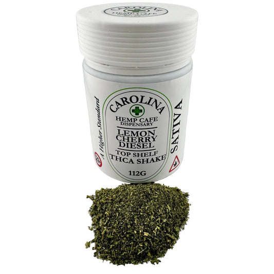 Jar of dried herbs with a label on a white surface