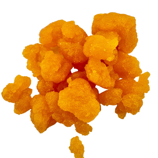 Cluster of orange-yellow gummy bears on a white background