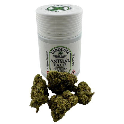 Container labeled 'Animal Face' with cannabis buds on a white background