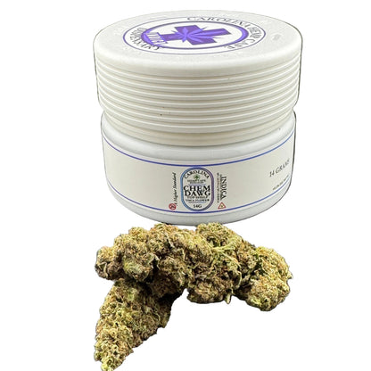 A white plastic jar of Lavogainz Cream Cream 14 G/10% CBD oil with a purple logo, shown next to a dried cannabis bud on a dark gray background.