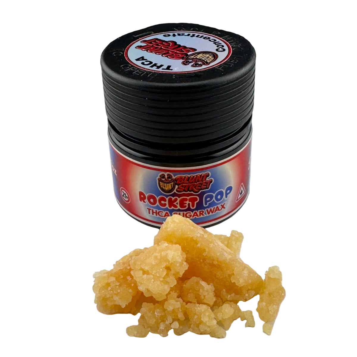 A small black jar of Shiny Legs Rocket Pop thick sugar wax with a red and blue label, placed on a white surface with a small pile of yellow wax in front.