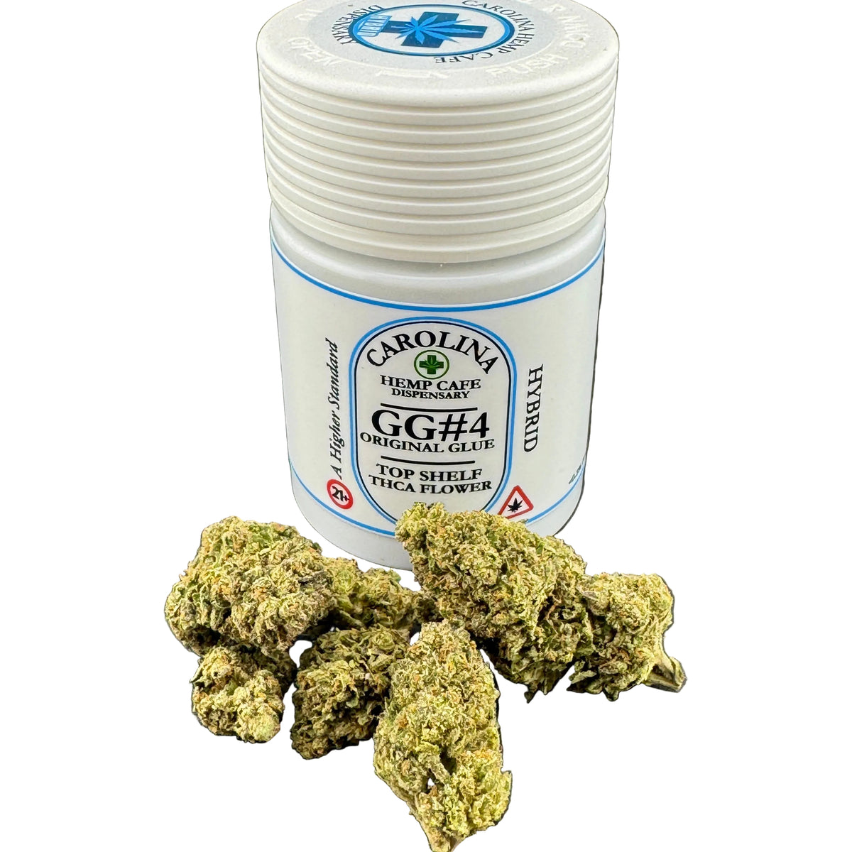 A white plastic jar labeled Carolina Hemp Cafe dispensaries GG#4 Original Glue Hybrid THCA flower, shown with several green dried flower buds in front on a dark gray surface.