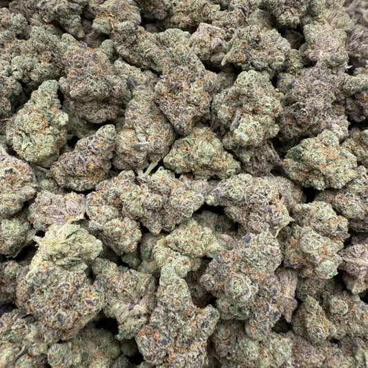 Close-up of a pile of green cannabis buds on a white background