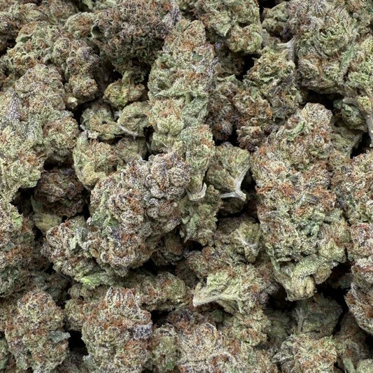 Close-up of dried cannabis buds on a gray surface